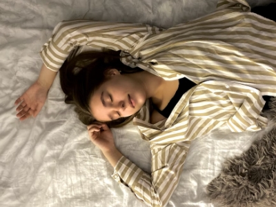 woman wearing stripes sleeping in a different position