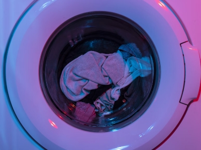 Clothes inside a washing machine on led lights